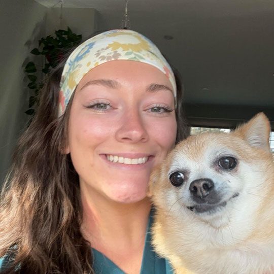 Dr Flemming smiling with small dog